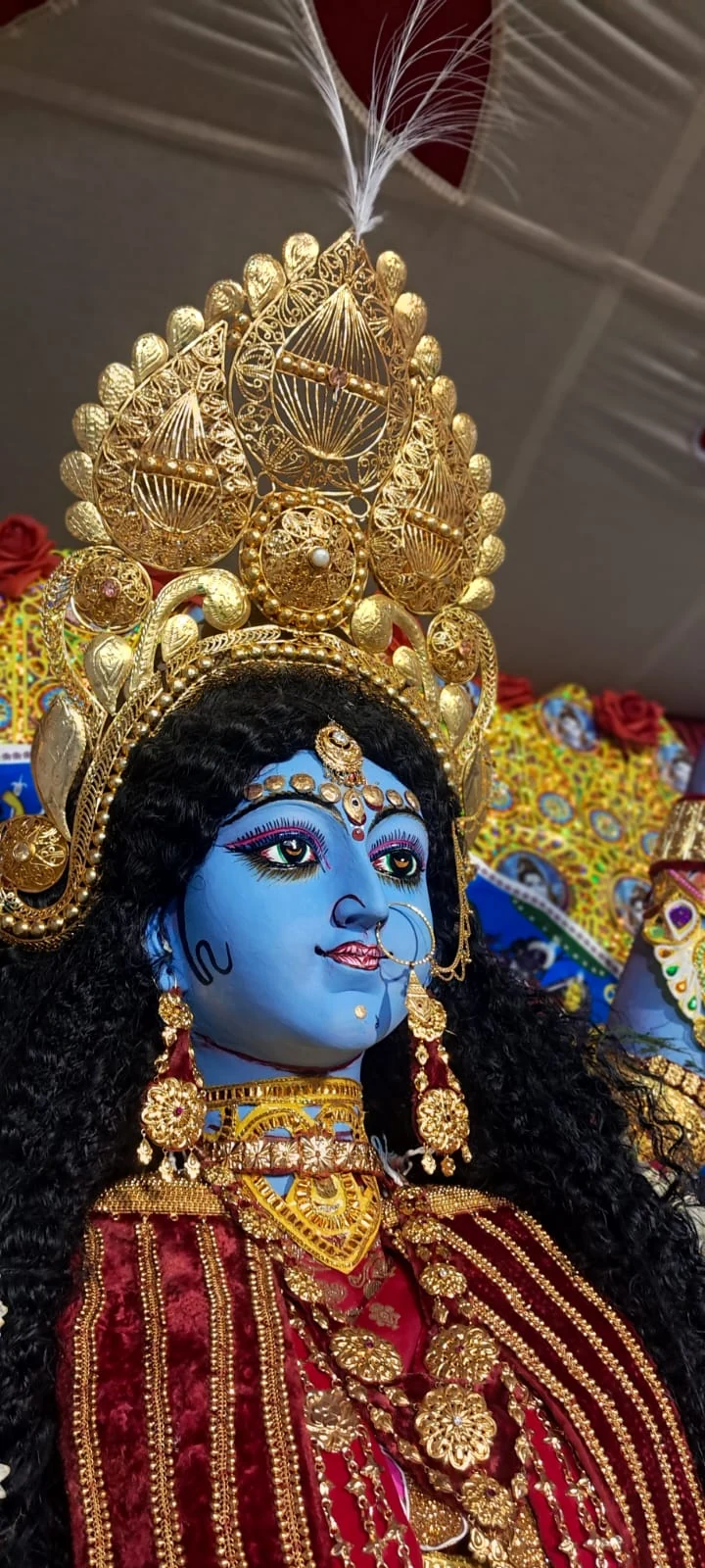 Close-up of Maa Neel Durga with blue complexion and golden crown